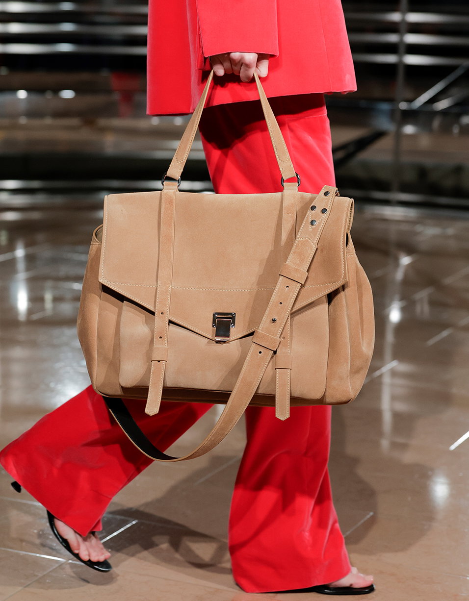 Cropped image of model holding the PS1 Walker bag on the Spring 27 Runway