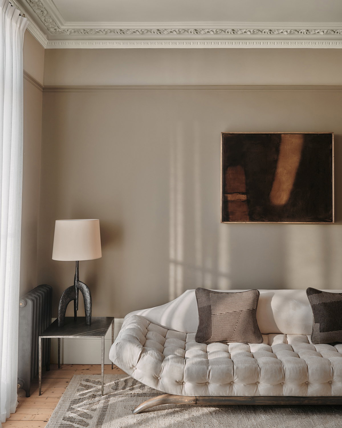 Bedroom painted in Farrow & Ball Mouse's Back, featuring layered neutral textiles and soft, earthy tones.