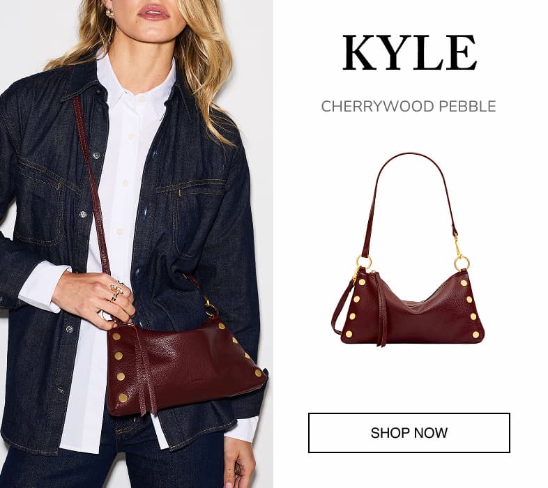 Kyle in Cherrywood Pebble, a deep burgundy leather shoulder bag with gold rivets and hardware, shown worn by a model and as a product image. SHOP NOW.