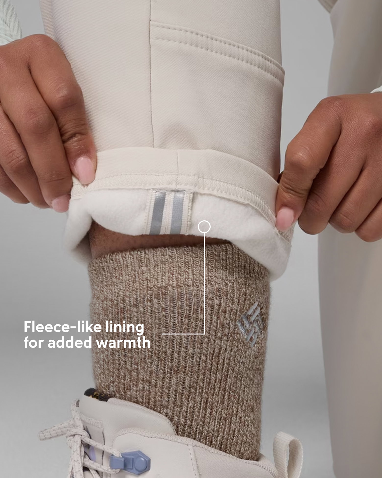 Close-up of the fleece-like lining of a white pair of pants with text: Fleece-like lining for added warmth.