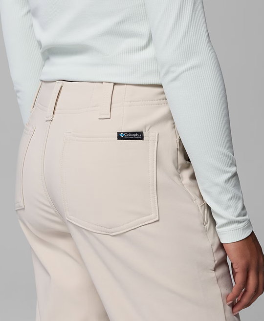 A model facing away, wearing white pants.