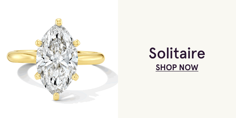 Gold ring band with large marquise-cut diamond center stone. Solitaire. Click here to shop now