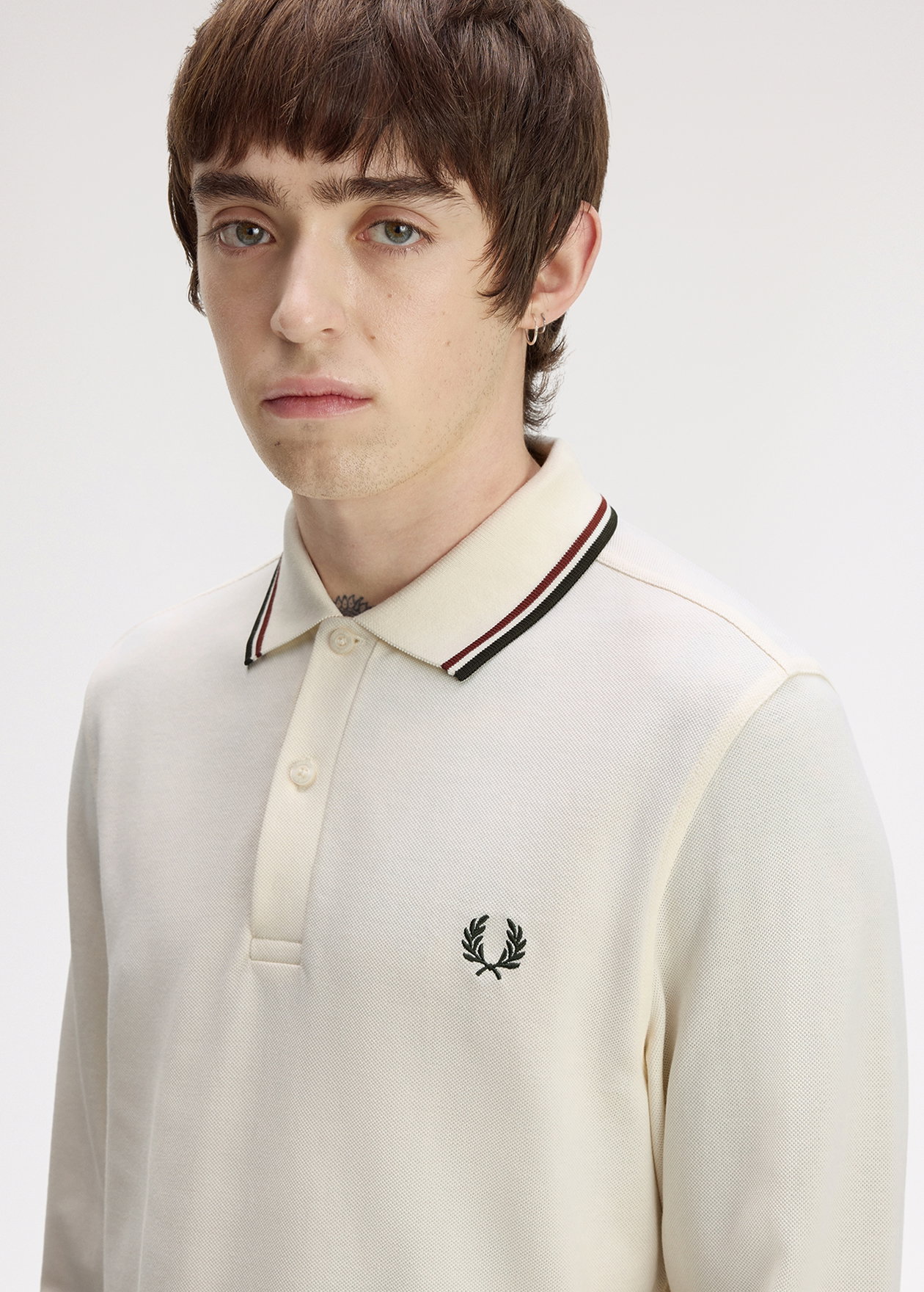 Male model wearing a M3636 Long Sleeve Twin Tipped Fred Perry Shirt in Ecru / Brandy / Night Green