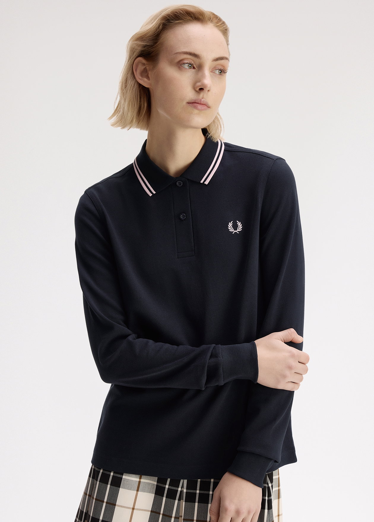 Female model wearing a G3636 Long Sleeved Fred Perry Shirt in Navy / Iced Pink / Iced Pink