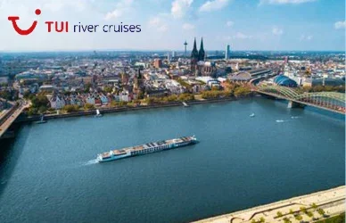 River cruise ship sailing through a city with cathedral spires and the TUI river cruises logo.