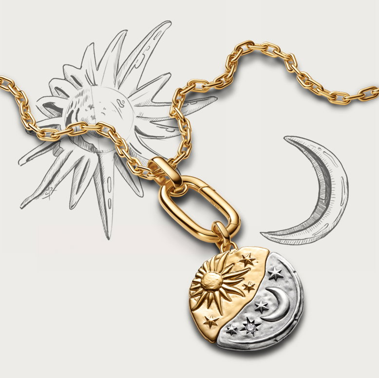 A close-up of a Pandora Talisman sun and moon medallion.