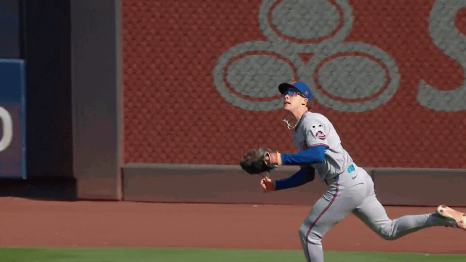 An animated gif of Carson Benge making a diving catch.