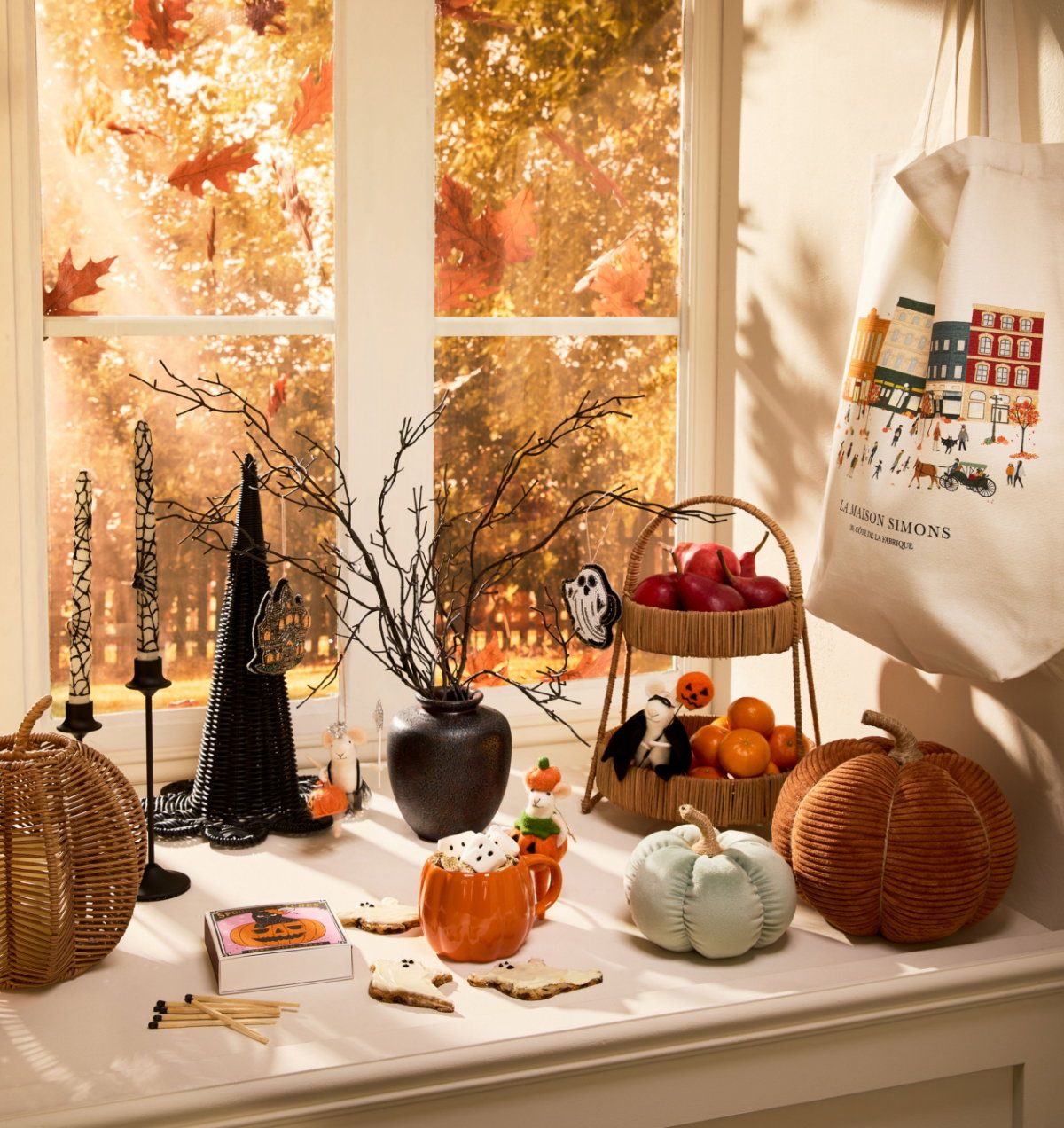 An autumnal atmosphere with a large display counter filled with a variety of fun Halloween decorations, including the Ribbed chenille knit pumpkin at 25$.