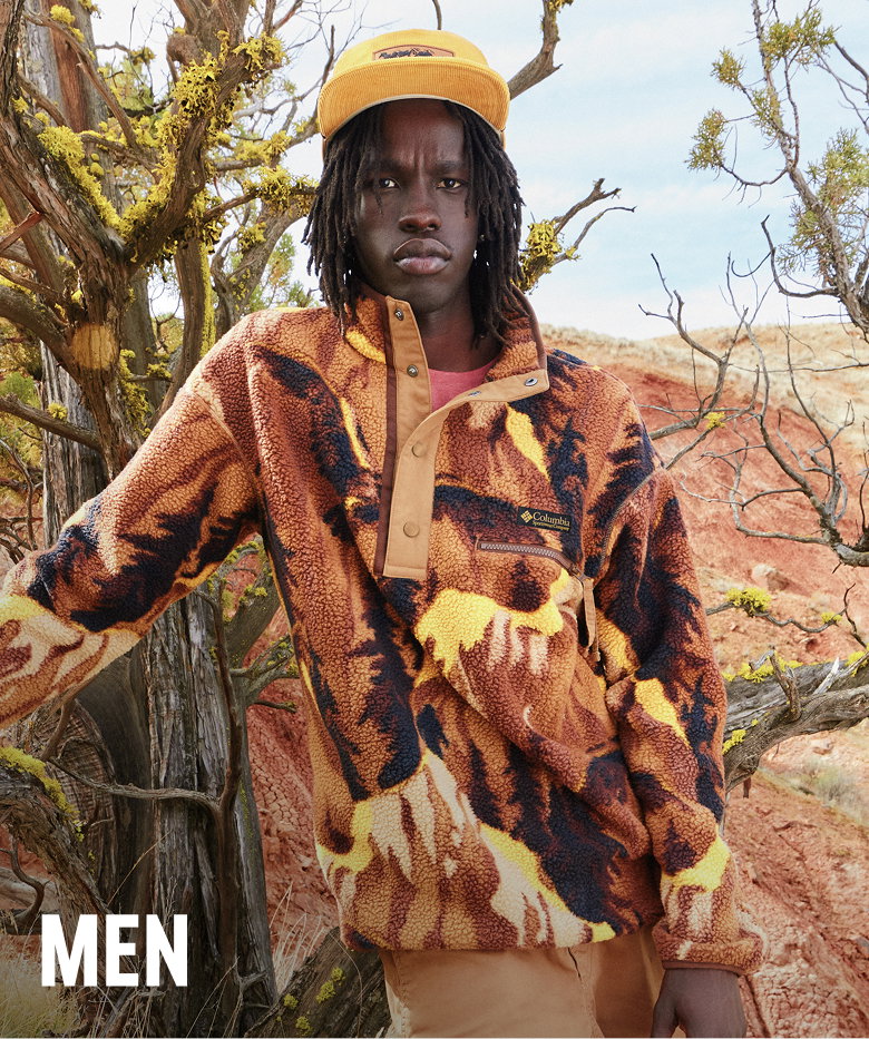A male model outside in arid environment wearing Helvetia fleece. 