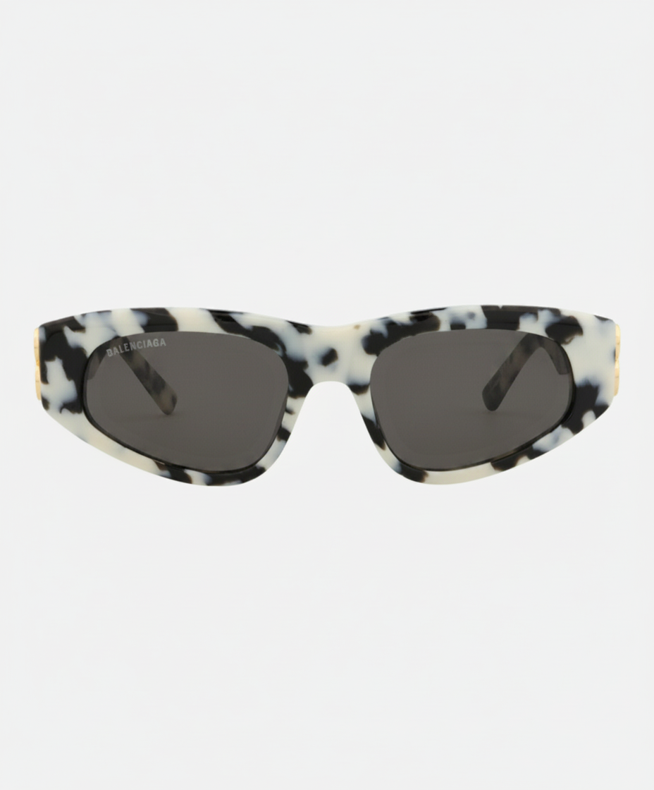 Balenciaga sunglasses with a black and white marbled frame and dark lenses.