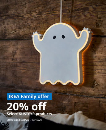 A KUSTFYR LED ghost decoration hangs on a wall.