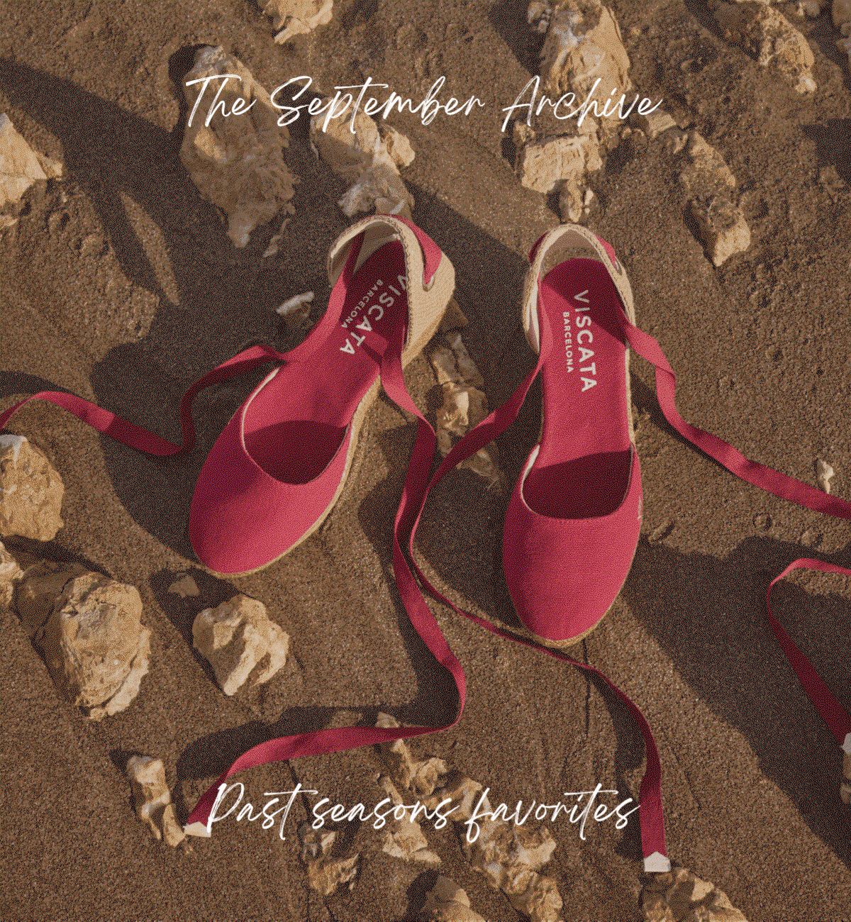 Woman holding Estartit pink floral ankle-strap espadrille wedges.