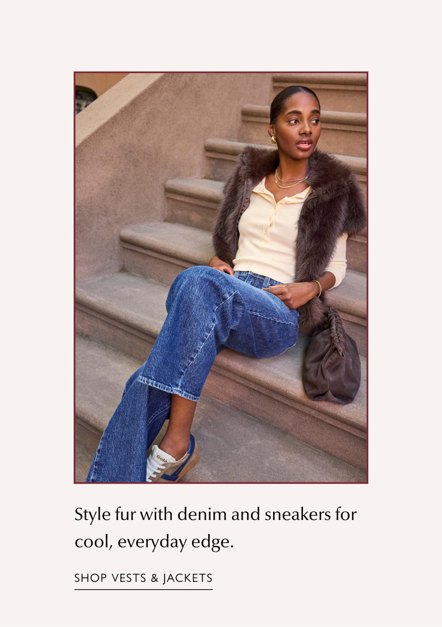 Style fur with denim and sneakers for cool, everyday edge. Image of fashion model resting on stoop in a half fancy vest. SHOP VESTS & JACKETS