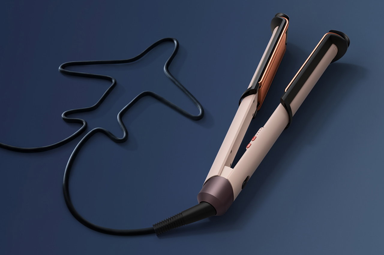 Dyson Corrale CoolShine hair straightener with cable shaped like an aeroplane.