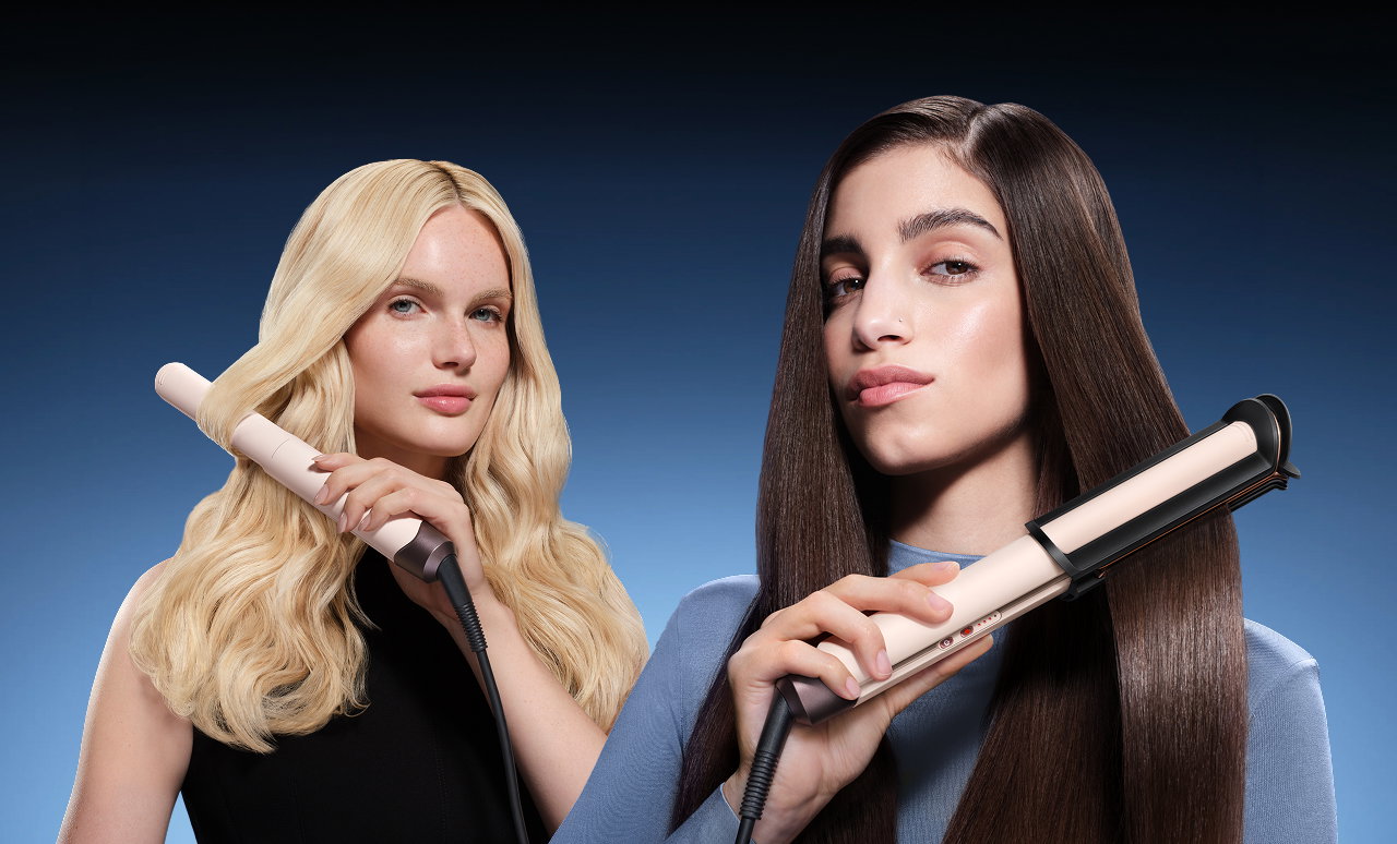 Pair of models style their hair with the Dyson Corrale CoolShine hair straightener.