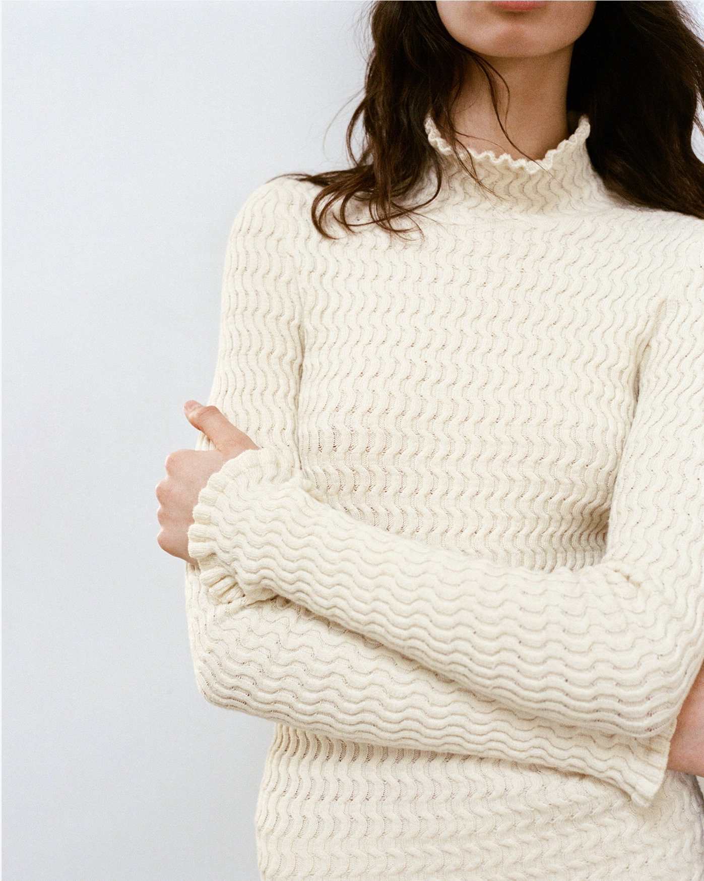 Cropped Campaign Image of model wearing the White Label Juniper Sweater in Cable Knit in Vanilla