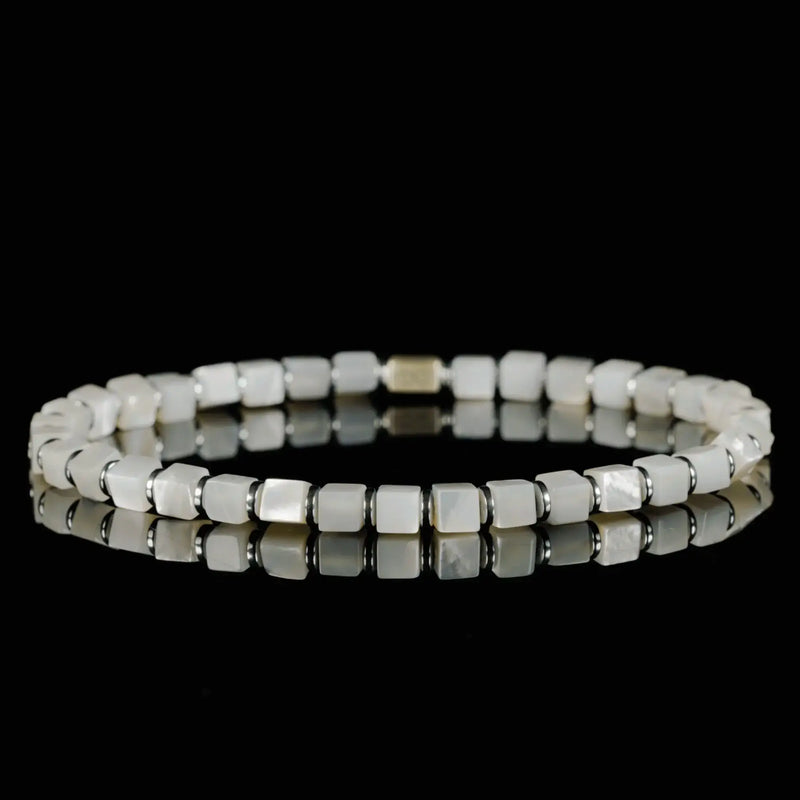Pale square beads with a reflective surface and silver details.