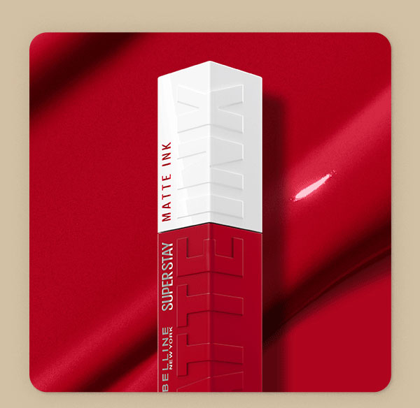 Top of a Maybelline Super Stay Matte Ink Liquid Lipstick bottle in Pioneer, a vivid red shade, set against a rich red satin backdrop with a swipe of glossy textured shade swatch.