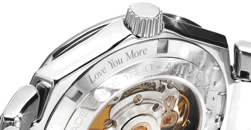 The back of a silver watch face with Love You More engraved. 