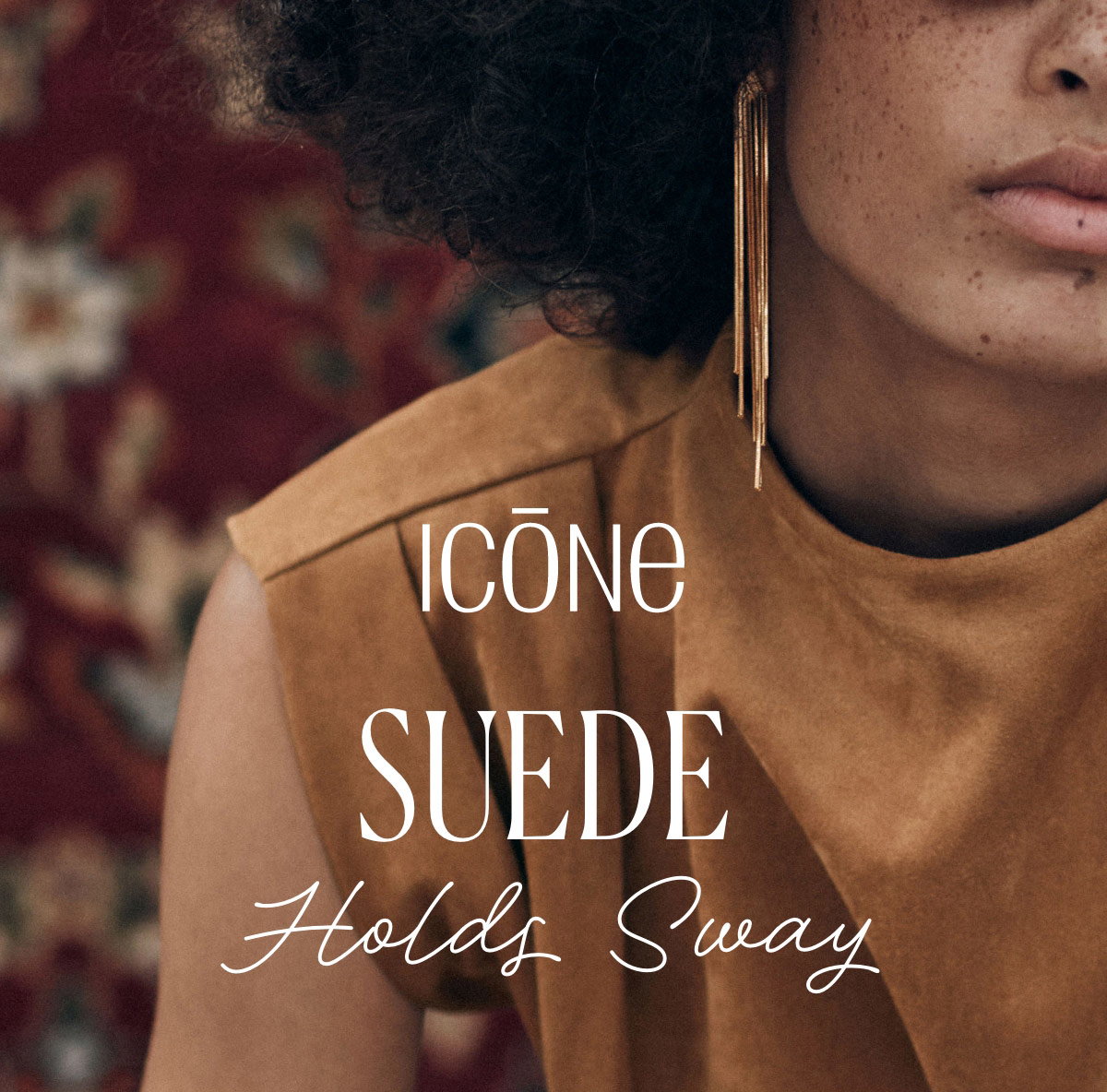 Icône Suede Holds Sway. Woman wearing a sleeveless faux-suede top, sunglasses, and long gold earrings.