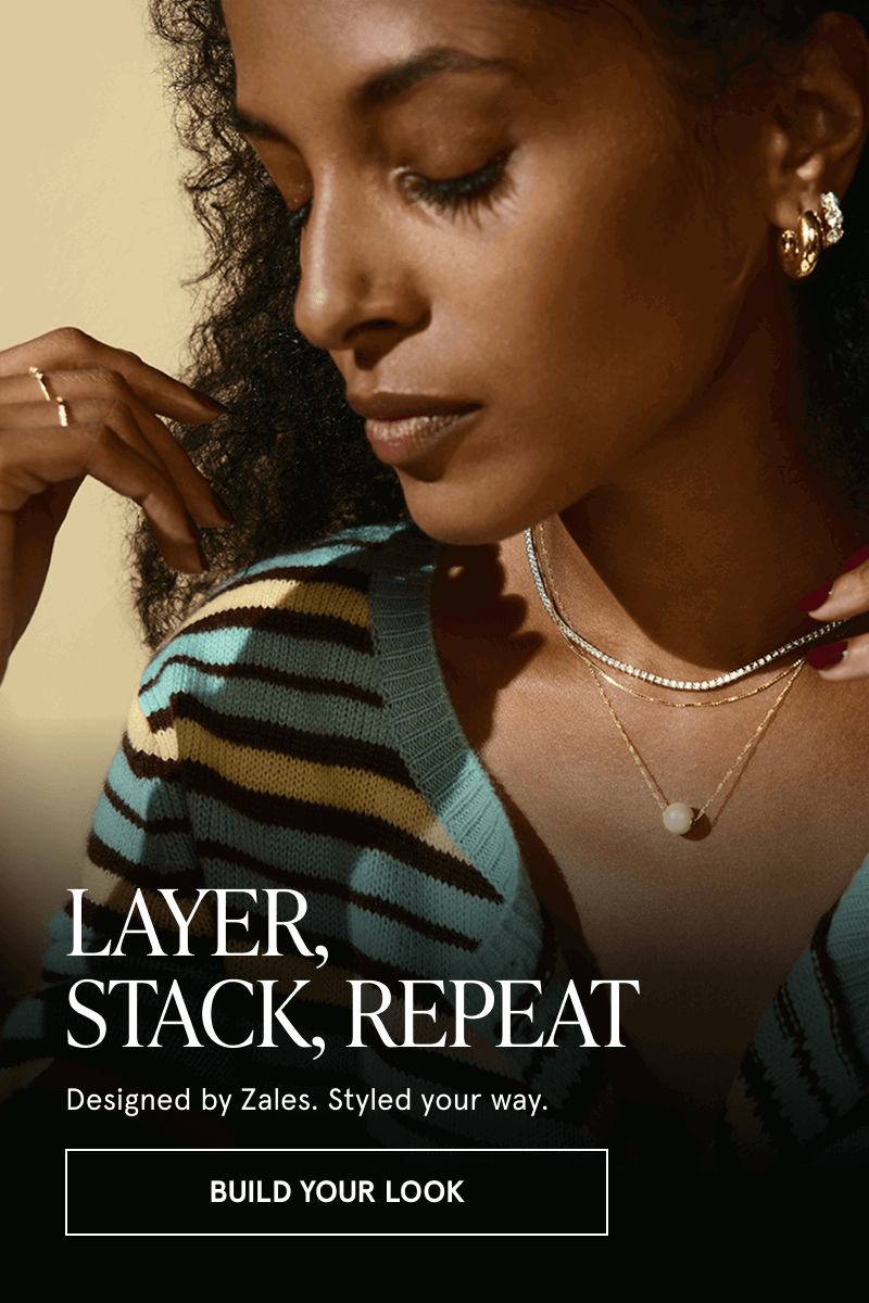 Model layered in gold & diamond necklaces with delicate pearl pendant & gold hoop earrings & rings. Click here to build your look