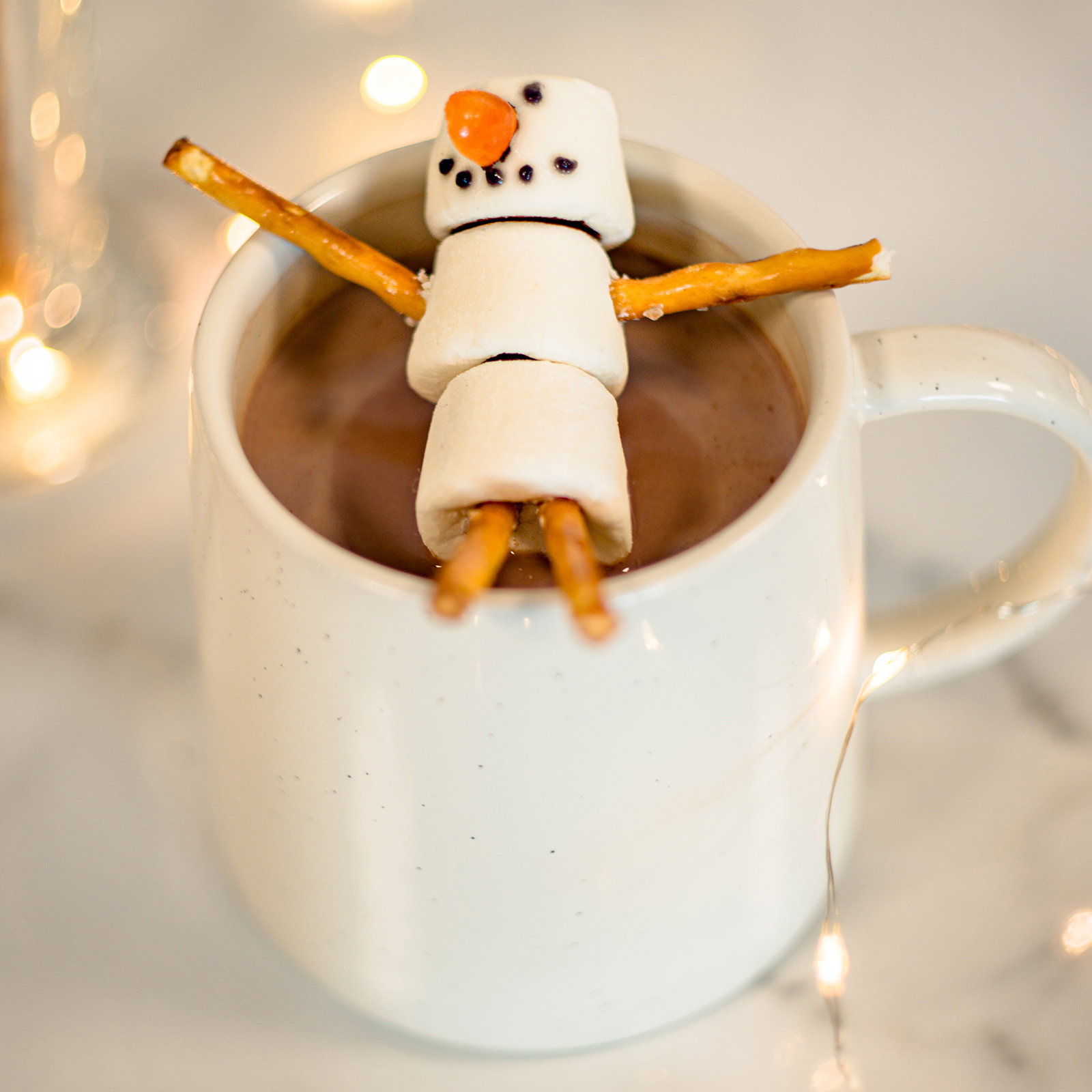 Image of snowman made from marshmallows on hot chocolate mug