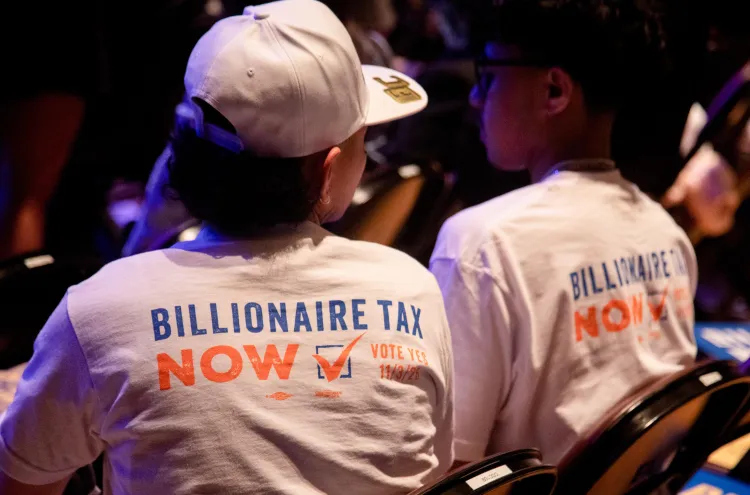 Attendees wear “Billionaire Tax Now” shirts during a campaign kickoff event for the California Billionaire Tax Act on February 18, 2026, in Los Angeles, California. Tim Rue/Bloomberg via Getty Images