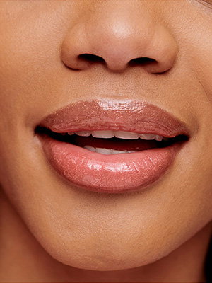 Woman's hydrated lips wearing lip gloss