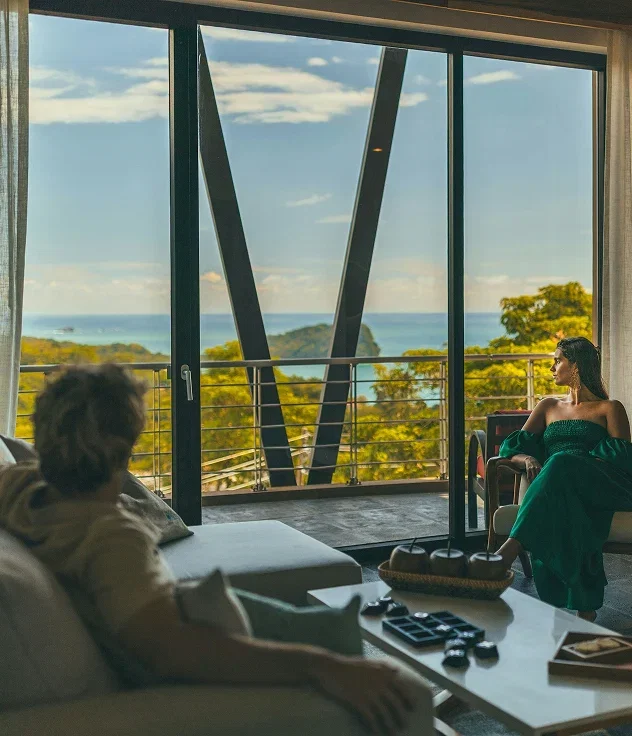 Guests relaxing in a suite with ocean views.