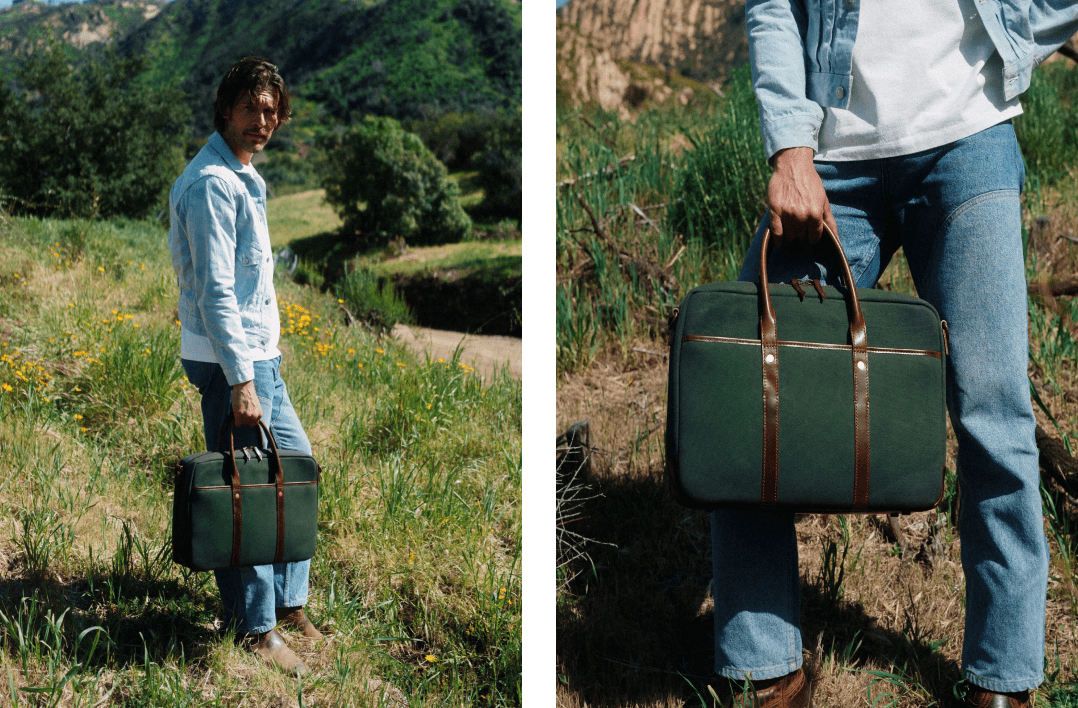 Man in a denim jacket carrying a green canvas and brown leather briefcase in a grassy field, with a close-up of the bag's handles and trim.