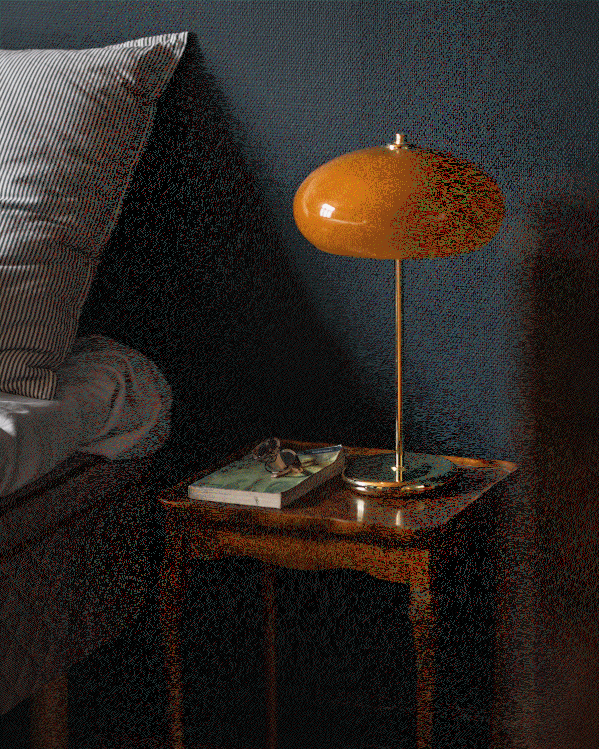 Animated GIF showcasing two featured colour schemes: a cosy Hague Blue bedroom with a vintage wooden bedside table and amber lamp, transitioning to a warm and welcoming Hay kitchen.