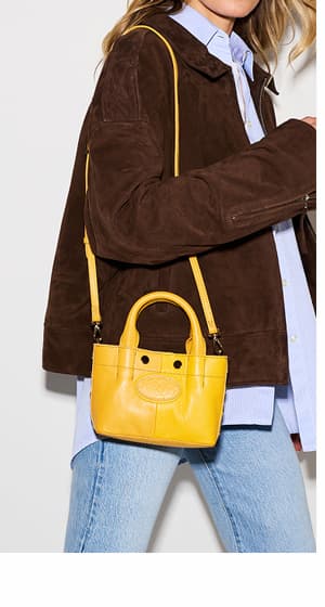  model with olympia-tote-mini-crossbody-double-yellow-gold
