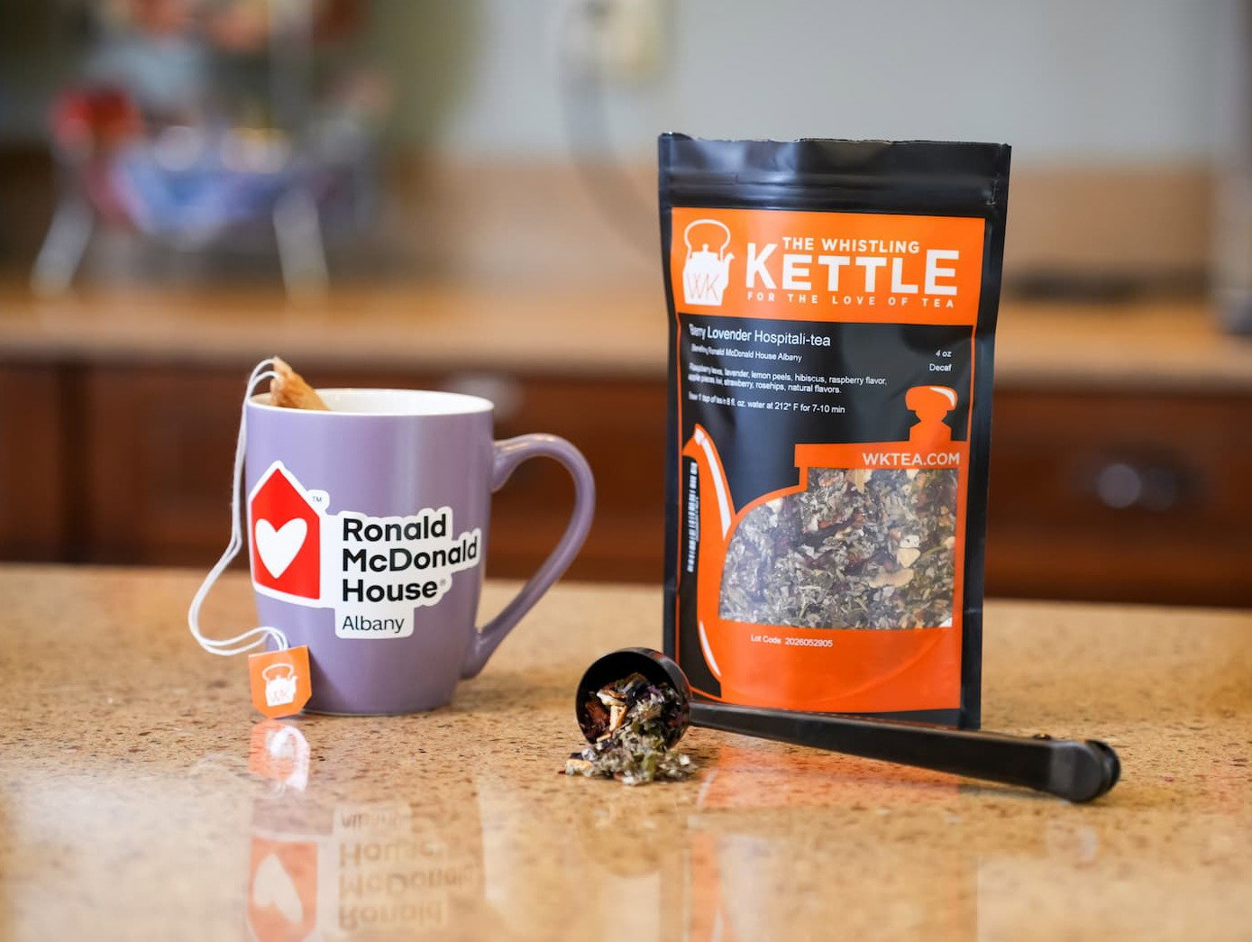 a cup of hot berry lovender next to a bag in a kitchen