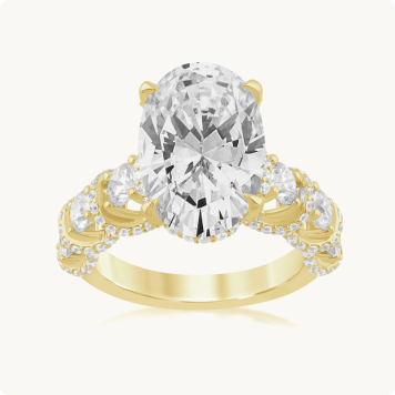 Oval Lab Grown Diamond 7 7/8ctw. Lace Cathedral Engagement Ring in 14k Yellow Gold: Yellow gold engagement ring featuring a large oval-cut diamond flanked by cascading pear-shaped side stones, with pavé diamonds lining the entire band.