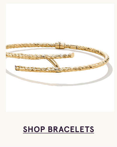A textured, open-style gold wrap bangle with a twist design. Click here to shop bracelets