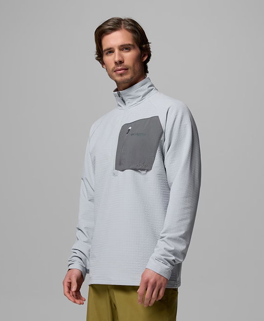 A man wearing a gray half zip pullover.