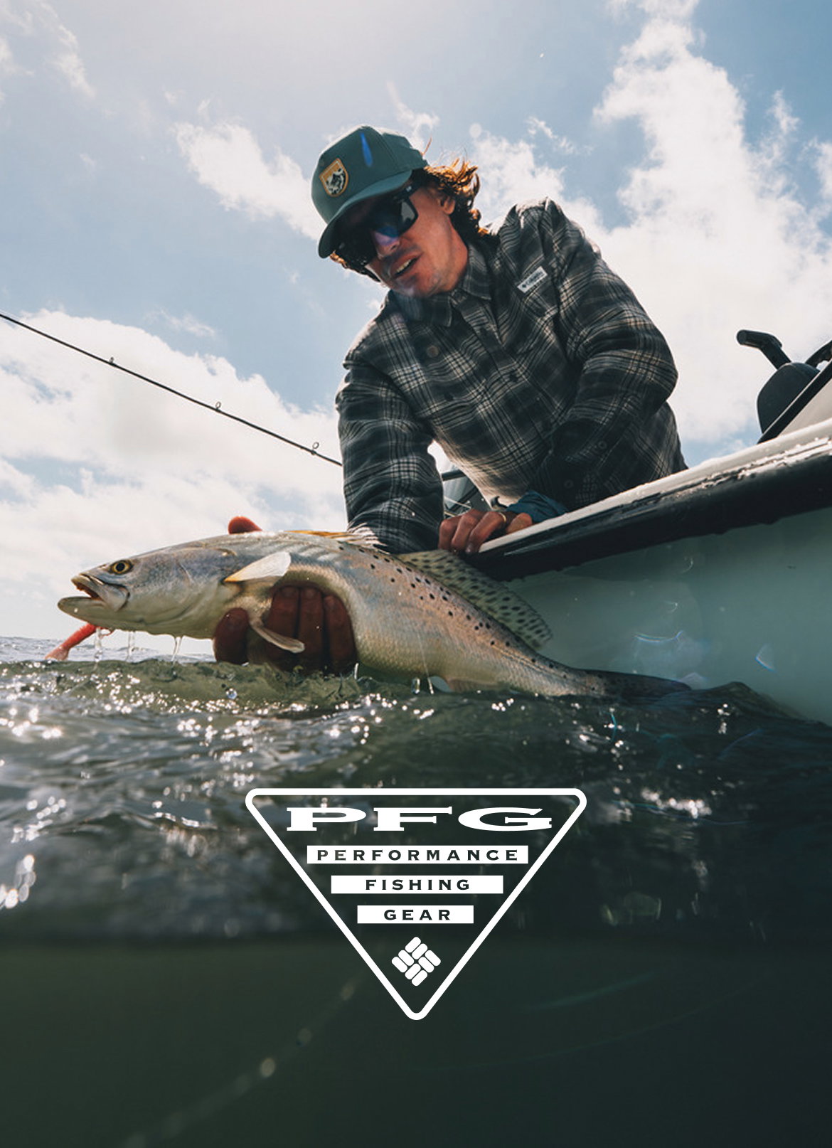An angler holding a fish in his hand as he leans out of the boat with the PFG logo at the bottom.