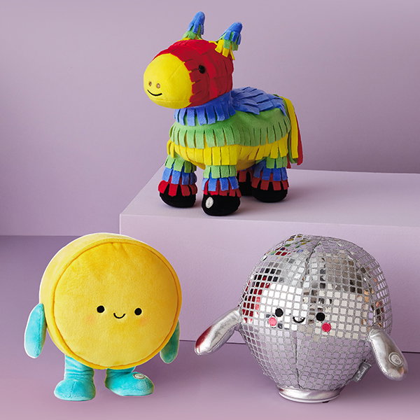 Three dancing musical plush: a piñata, wheel of cheese, and a disco ball.