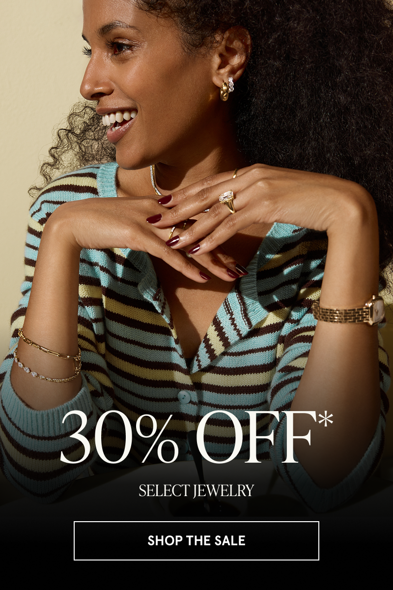 Model with emerald cut diamond ring, hoops, watch & delicate bracelets. 30% OFF Select Jewelry. Click here to shop the sale