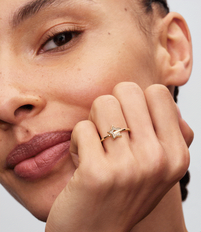Model wears a stack of lab-grown diamond heart and star rings
