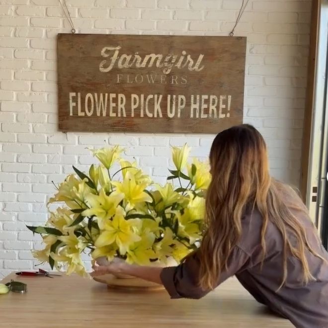 Christina arranging lilies in a DIY tutorial on Instagram.