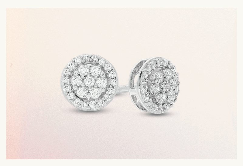 A pair of round composite cluster diamond stud earrings.