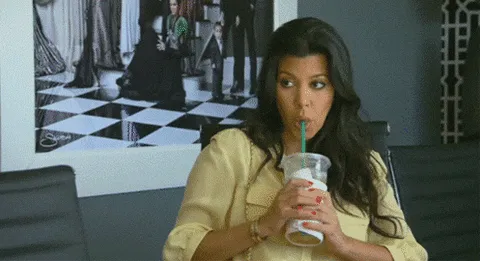 Kourtney Kardashian sipping a Starbucks iced coffee.