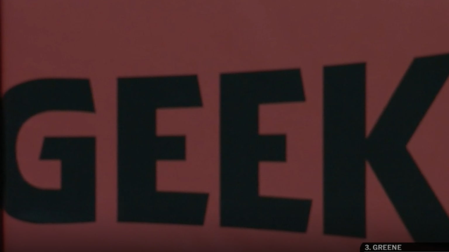 A screenshot from the Tigers broadcast of the letters 'GEEK' on the outfield wall