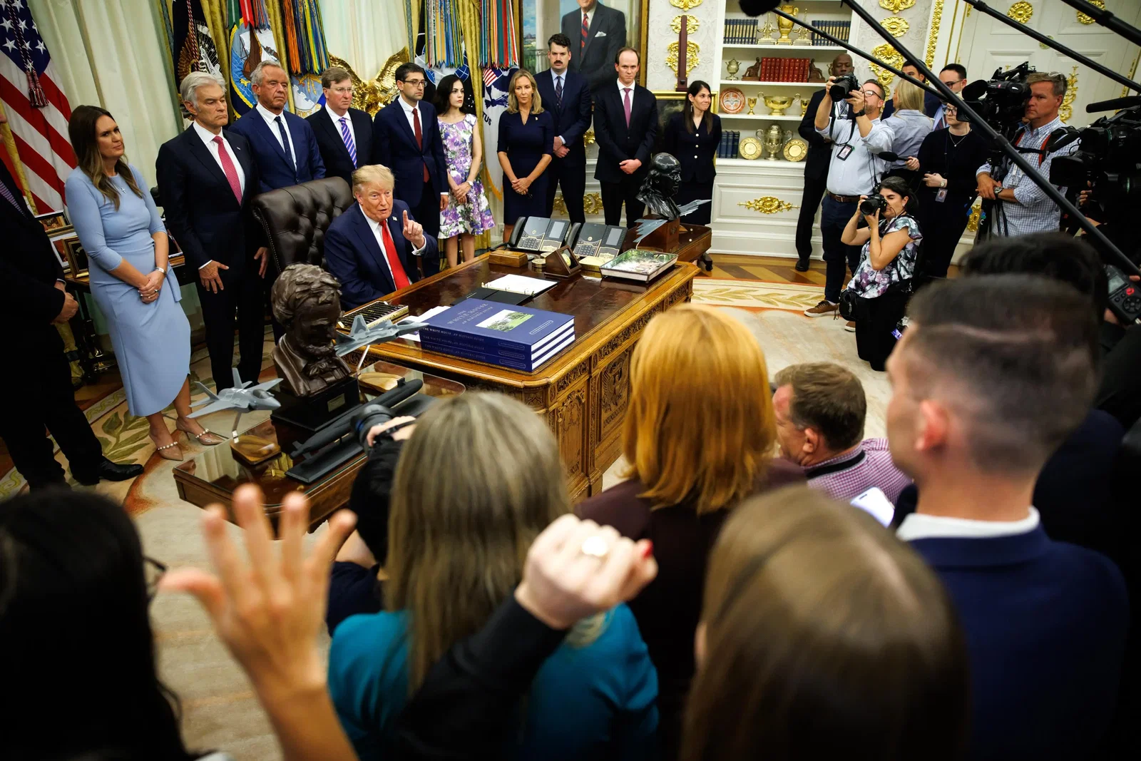 Trump, in a navy suit and red/blue striped tie seems to shout at NATO Secretary General Mark Rutte, who is seated next to Trump in the Oval Office.