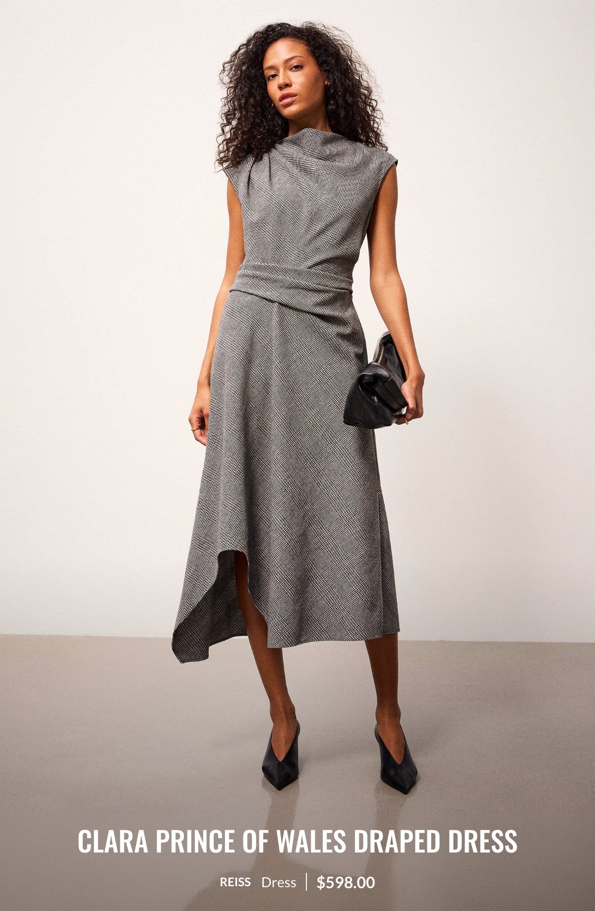 Woman wearing the Clara Prince of Wales Draped Dress at 598.00$