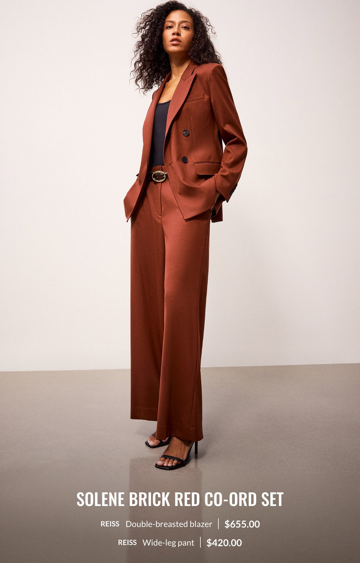 Woman wearing the Solene brick red co-ord set: double-breasted blazer at 655.00$ and wide-leg pant at 420.00$