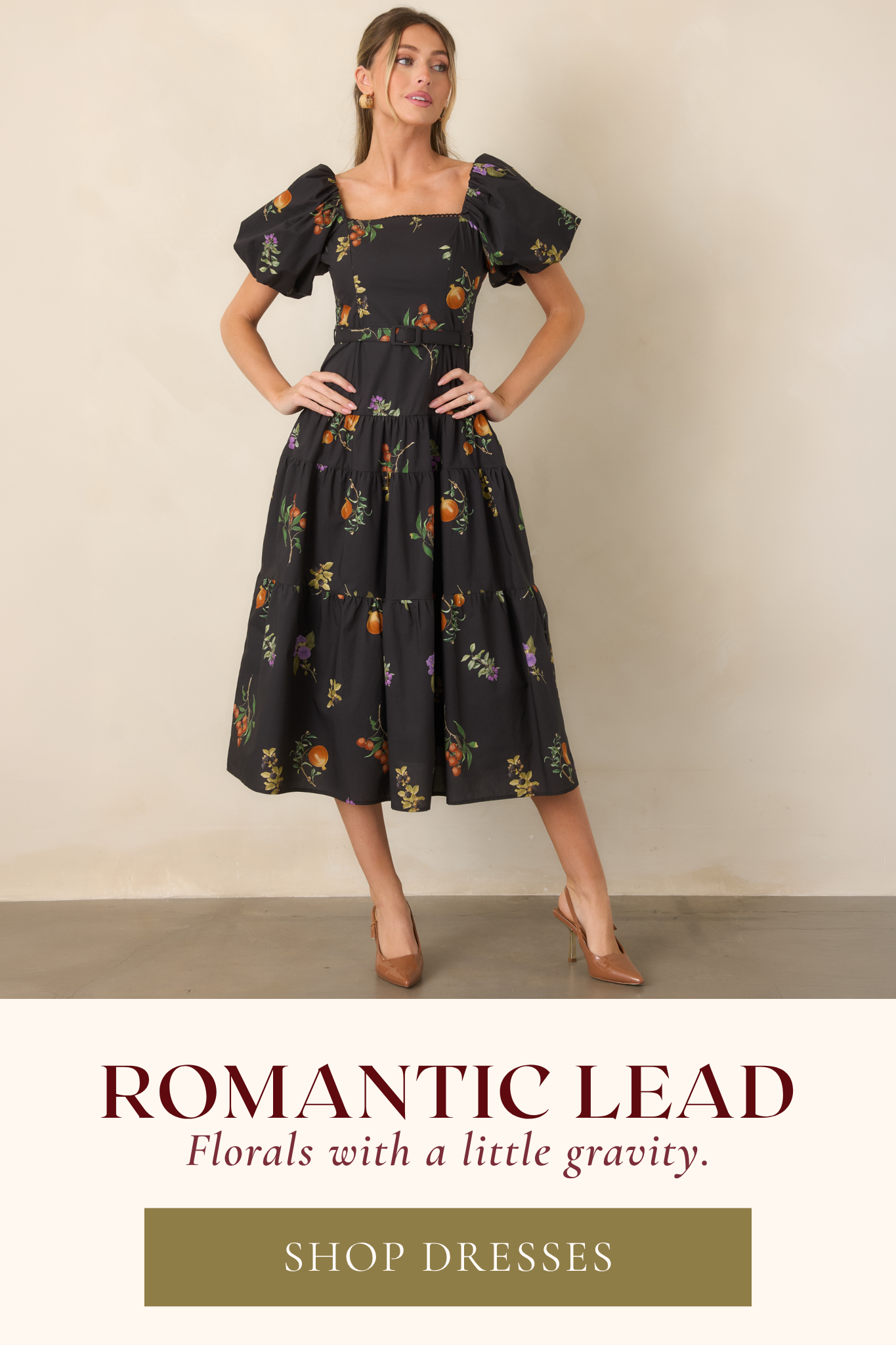 'Shop Dresses.' Model wearing a black floral midi dress.