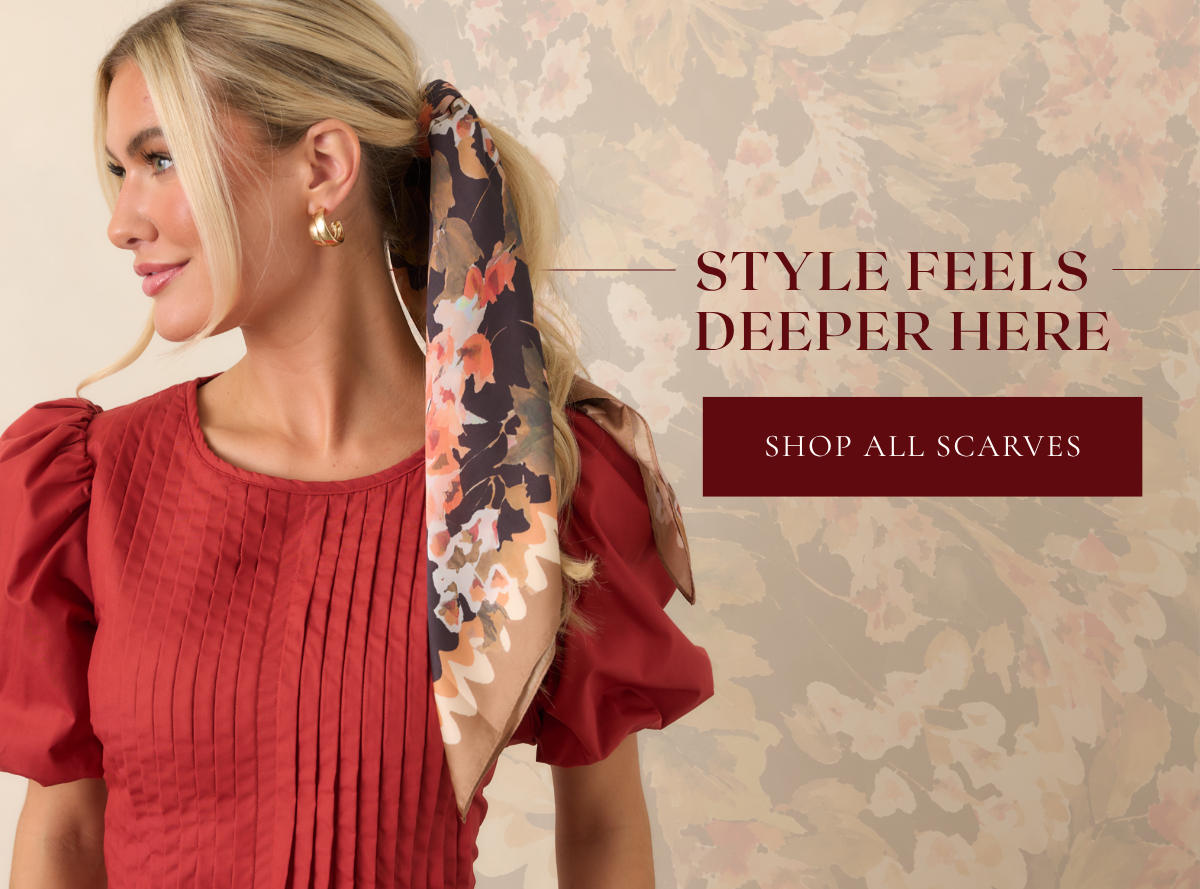 'Style feels deeper here. Shop all scarves.' Model wearing a floral scarf.
