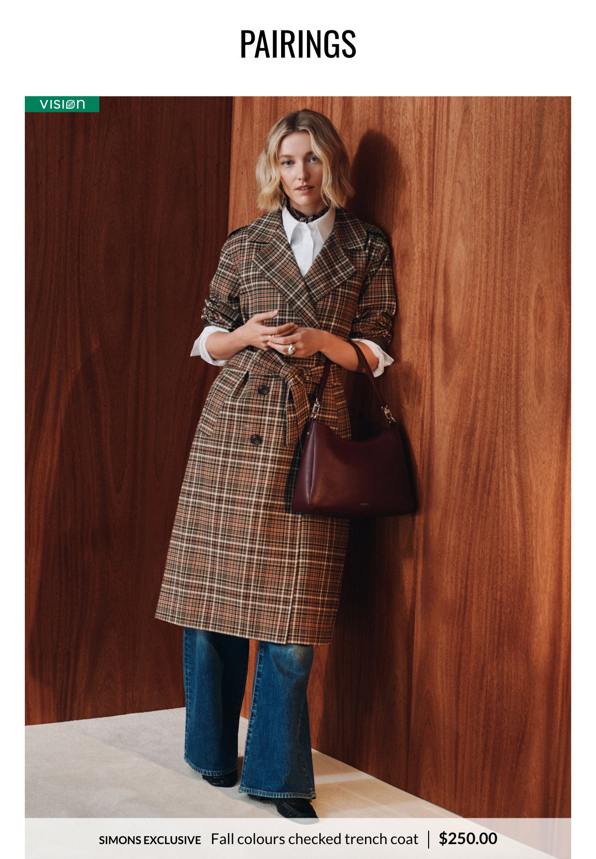 Woman wearing a checked trench coat in fall colours at 250$.